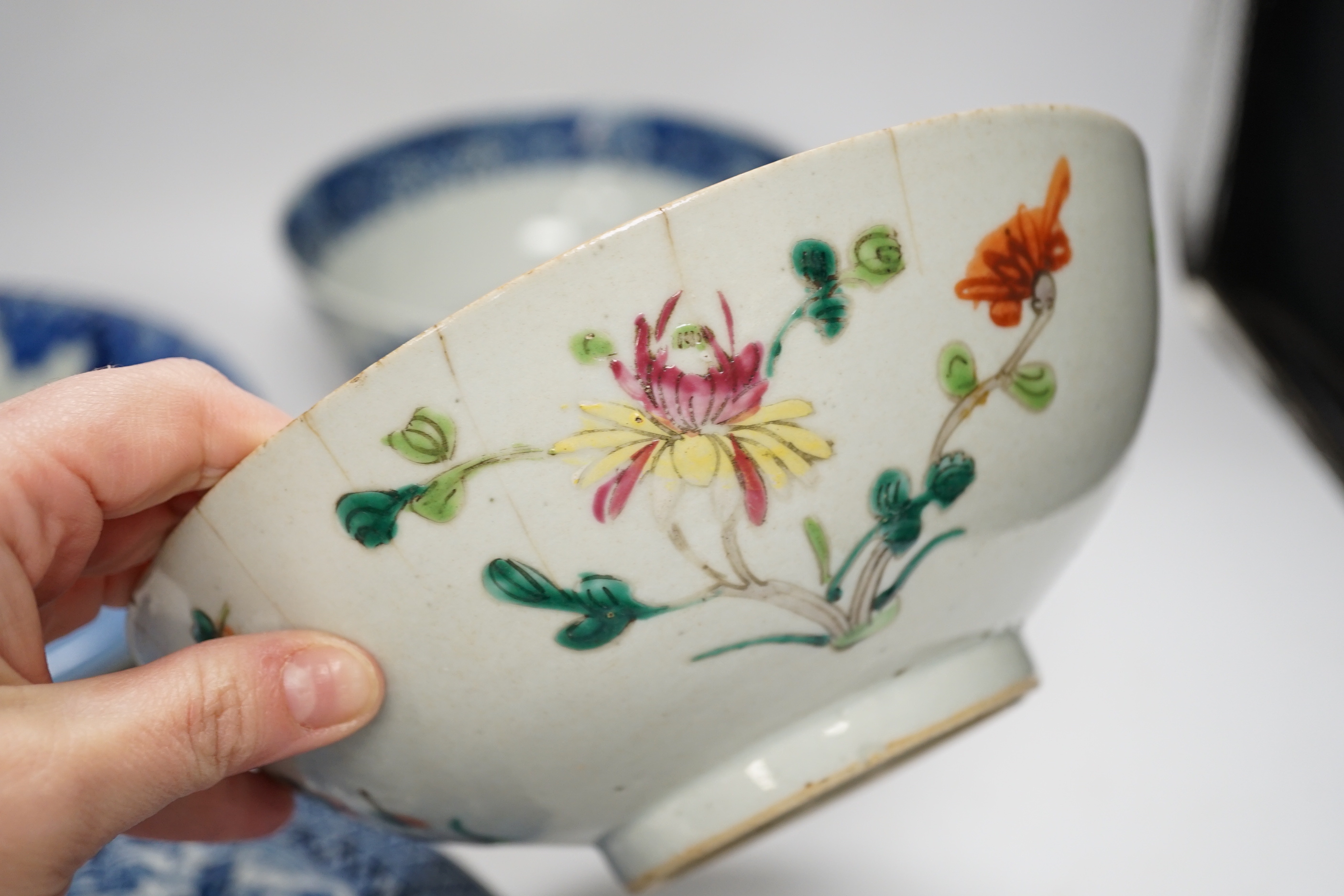 Assorted Chinese and Japanese ceramics comprising a famille rose bowl, two blue and white plates and a blue and white bowl, largest 30cm in diameter